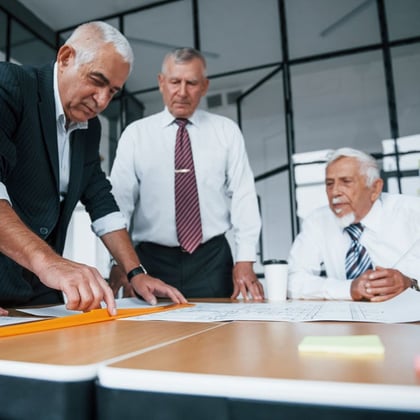 A group of senior men in a meeting