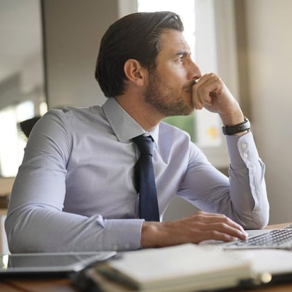 A worried businessman at a computer