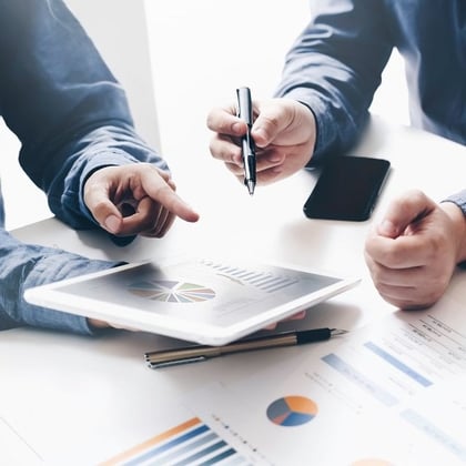 An advisor and a client working with the same tablet